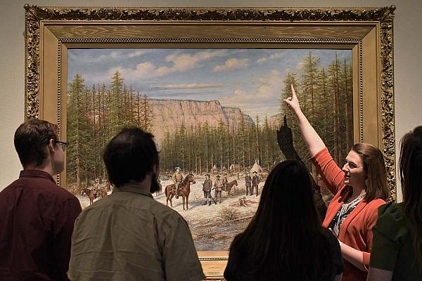 Exclusive Tours guide Kirsten shows a painting in the Buffalo Bill Museum.