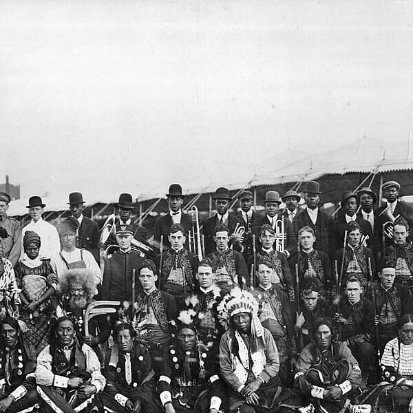 Large group of people, some with musical instruments.